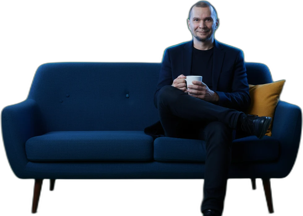 Andrei on the couch, coffee in hand — the kettle’s on.